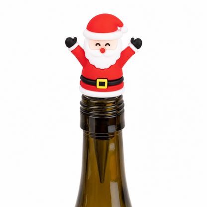 A festive Christmas wine bottle stopper shaped like a smiling Santa Claus, featuring a red hat with white trim, white beard, black gloves and belt, and a small gold buckle detail, shown on top of a dark glass wine bottle against a plain white background.