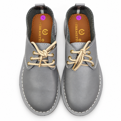 Grey lace-up veldskoen made from genuine leather in South Africa. True-to-size fit, with minor cosmetic imperfections that don’t affect durability. Shop online.