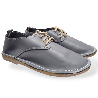 Grey lace-up veldskoen made from genuine leather in South Africa. True-to-size fit, with minor cosmetic imperfections that don’t affect durability. Shop online.