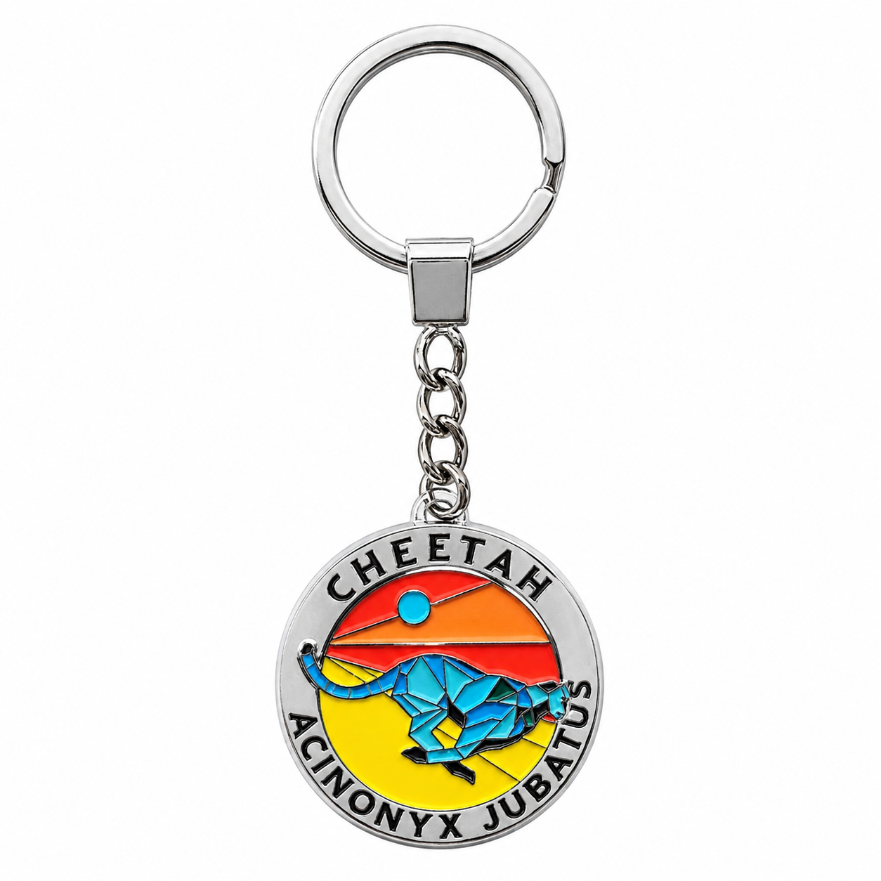 A silver metal keychain featuring a circular charm with the words 'CHEETAH' and 'ACINONYX JUBAUS' surrounding a colorful illustration of a blue cheetah against a yellow, orange, and red sunset background.