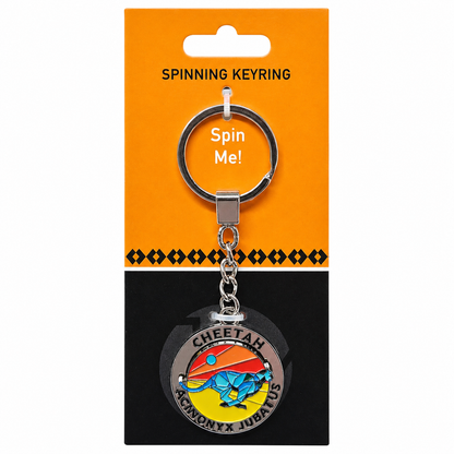 A silver metal spinning keyring attached to an orange and black retail card that reads 'SPINNING KEYRING' and 'Spin Me!'. The round charm features a colorful cheetah and sun design with the text 'CHEETAH ASTRONOMY X JUPITER'.