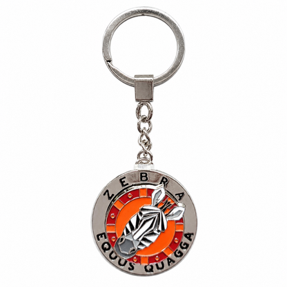A silver metal keychain featuring a circular charm with a zebra graphic and the words 'ZEBRA EQUUS QUAGGA' on a white background.
