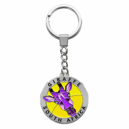 A silver metal keychain featuring a circular charm with a purple and yellow giraffe illustration and the text 'GIRAFFE SOUTH AFRICA'.