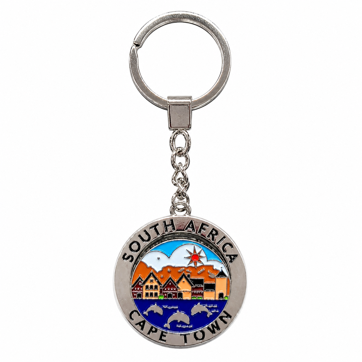A silver metal keychain featuring a circular charm engraved with 'SOUTH AFRICA' and 'CAPE TOWN' and decorated with colorful enameled artwork of Cape Town's skyline, mountains, and harbor.